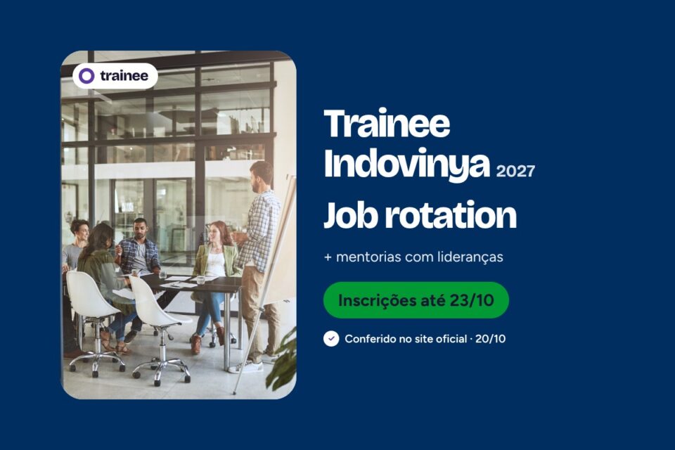 Equipe jovem reunida em mesa de sala envidraçada, com homem em pé ao lado de cavalete. Trainee Indovinya 2027: Job rotation + mentorias com lideranças. Engenharias, Formados 2024–2026, São Paulo (SP). Inscrições até 23/10.